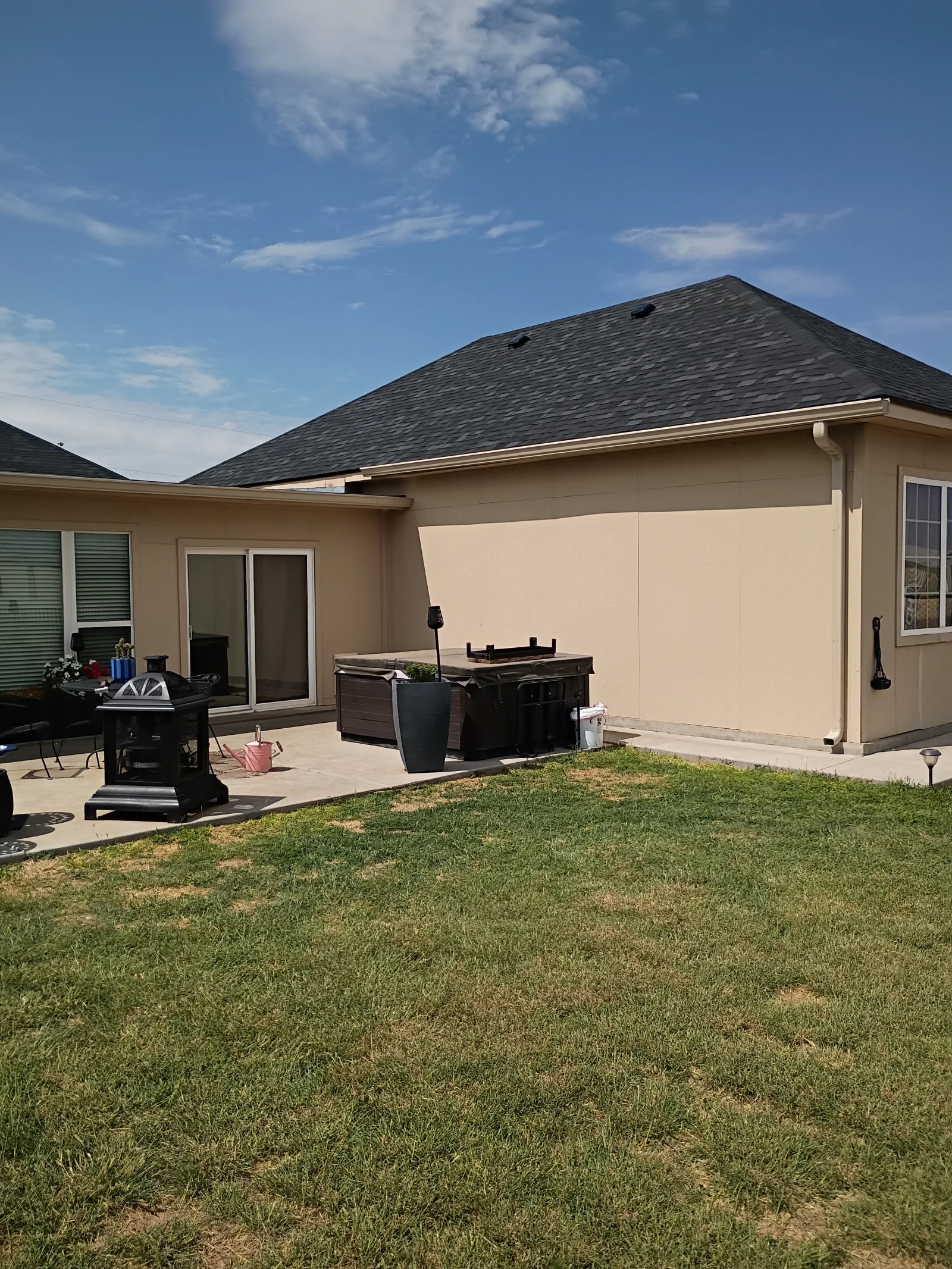 Charcoal gray architectural shingle roof on residential home with pitched design and roof vents